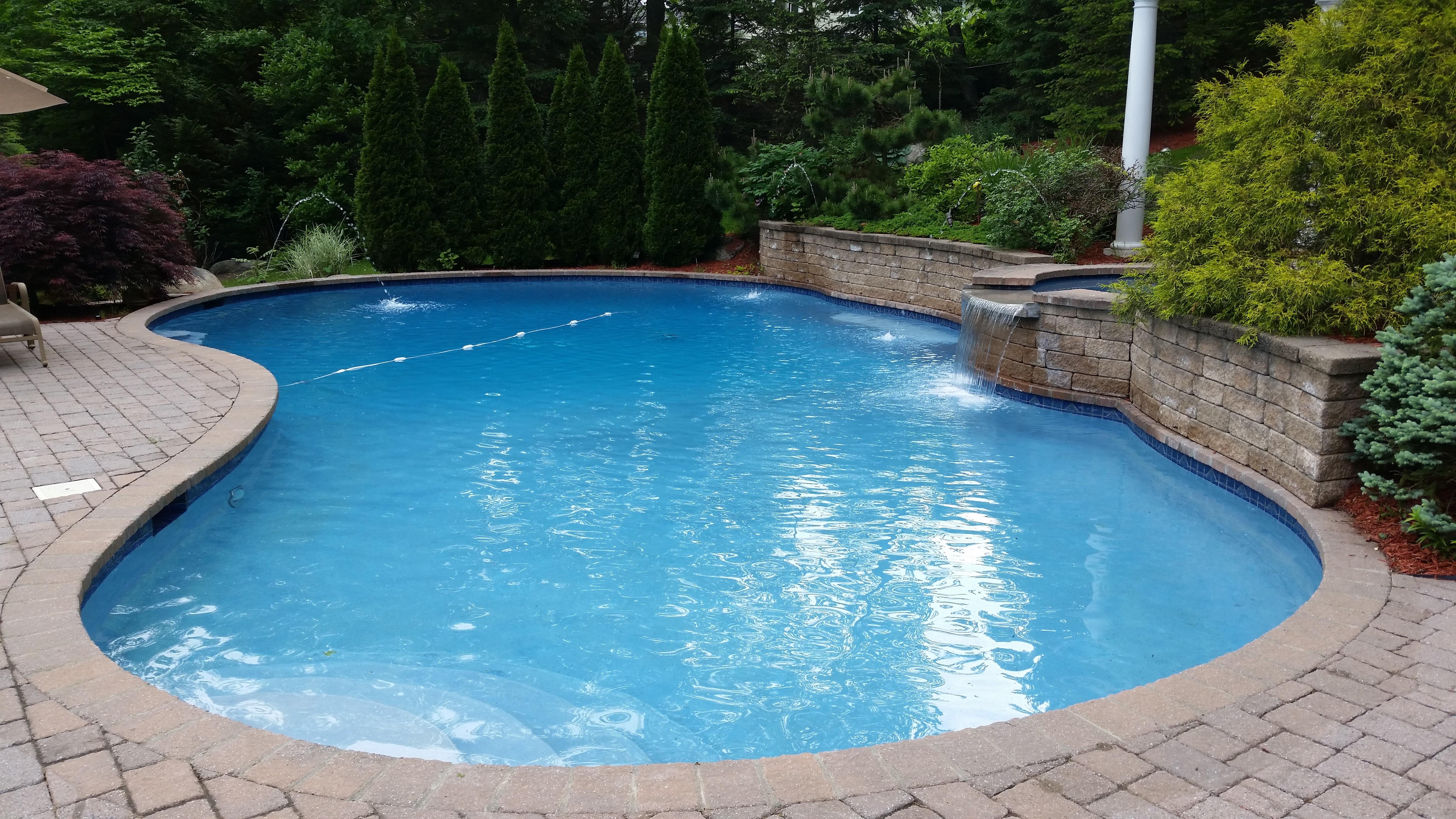 Curved freeform pool with stone surround